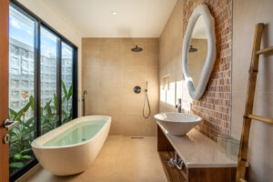 a bathroom with a tub and a sink and a mirror at e (1)